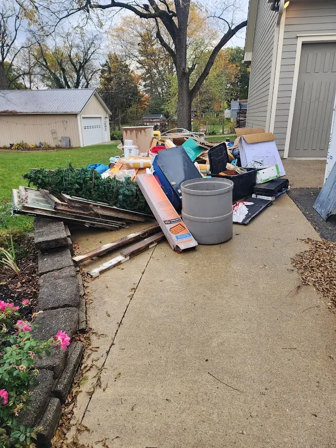 Dumpster being loaded with debris for Demolition Dumpster Rental in Cedar Creek